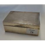 An early 20th century presentation silver cigarette box, with engine turned decoration and the