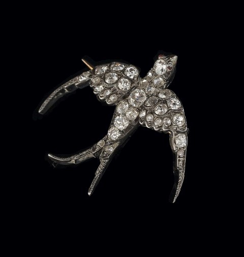 A late Victorian diamond swallow brooch, set throughout with mixed old cut and rose cut diamonds,