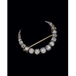 A late Victorian diamond crescent brooch, the graduated mixed old cut and cushion cut diamonds in