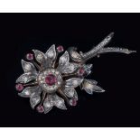 A late Victorian ruby and diamond flower brooch, set with rose diamonds and cabochon rubies,