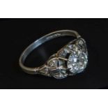 A single stone diamond ring, the old brilliant cut diamond in raised claw mount, with carved diamond