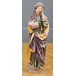 A carved wood, gilt and polychromic painted devotional figure of a saint, with The Book open and