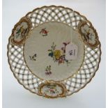 A 19th century late Meissen porcelain ribbon plate, decorated with sprigs and floral sprays within a