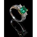 An emerald and diamond five stone ring, the central step-cut cut-cornered emerald with emerald-cut