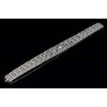 An Art Deco diamond bracelet, the tapering panels set with graduated old brilliant cut diamonds in