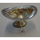 N and W, a silver pedestal bon bon dish, of helmet form, having feather cased rim and pierced bowl