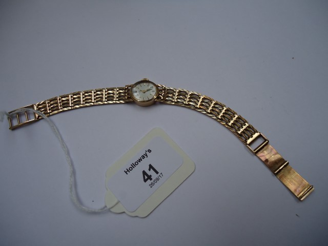 A lady's 9ct gold Rotary wristwatch, the oval dial with baton numerals and integral gate link