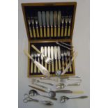 A twelve place canteen of fish knives and forks, each with silver collar and simulated ivory handle,