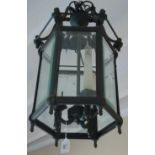 A Georgian design patinated brass and bevelled glass hanging hall lantern, 64cm high