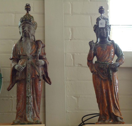 A pair of Chinese style large and impressive terracotta figural table lamps, in the form of an