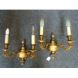 A pair of gilt brass George II design two branch wall sconces, with fruiting decoration with