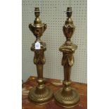 A pair of decorative gilt metal table lamps, of Baroque design, with urn and column motif, over a