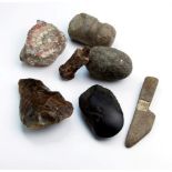 A collection of archaeological finds, to include knapping stone, flint axe heads, mosaic fragment,