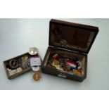 A box containing a collection of militaria items, including Queens South Africa medal with South