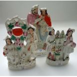 A Victorian Staffordshire figural group, 'Prodigals Return', a watch-holder group of a piper and