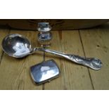 A white metal Beney 'Nuffield Products' table lighter, a silver plated fiddle and shell soup ladle