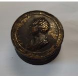 A cylindrical bronze box and cover, the threaded lid decorated with a profile bush of Charles