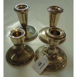 Two pairs of dwarf table candlesticks, each marked sterling