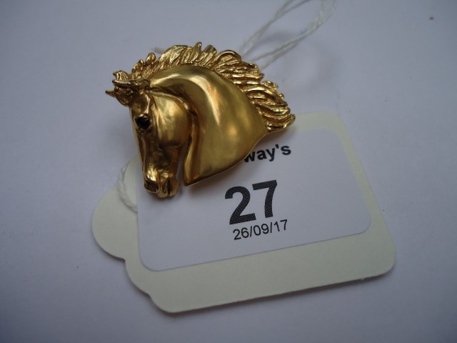 A 9ct gold horse brooch, the head and neck brooch with flowing mane and sapphire set eye