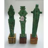 A collection of studio pottery totemic studies, in the neolithic manner, each with a verdigris