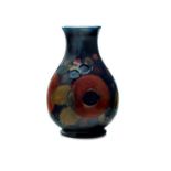 A Walter Moorcroft 'Pomegranate' pattern pottery baluster vase, with faux signature in green to