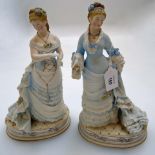 A pair of early 20th century continental bisque porcelain figures of ladies of fashion, 29cm high