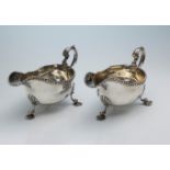 Elkington: A pair of silver sauce boats, gadrooned borders, leaf capped double scroll handles and