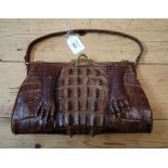 A vintage gilt metal mounted crocodile handbag, with paw and back ridge detail, the interior with