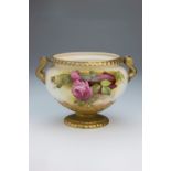 A Royal Worcester twin handled footed bowl, decorated with pink roses and foliage on a blush and