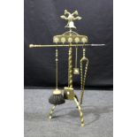 An early 20th century cast brass companion stand, with twin head spread eagle finial over five