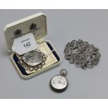 A pierced silver nurse's buckle, a continental silver cased lady's fob watch and a cased silver coin