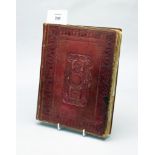 An early 19th century gilt and embossed leather bound scrap album, containing many sketches,