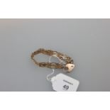 A 19ct gold gate link bracelet with padlock clasp