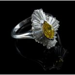 A canary yellow and colourless diamond dress ring, the marquise shaped canary yellow diamond in