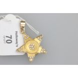 A diamond set star-shaped locket pendant, the five point star with three stone brilliant cut diamond