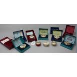 A collection of nine Bilston Battersea enamel/Halcyon Days Christmas pill boxes, late 1970s and