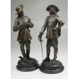 A pair of 19th century French bronze patinated spelter figures of cavaliers preparing to duel with