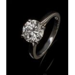 A single stone diamond ring, the brilliant cut diamond in raised four claw mount, to plain tapered