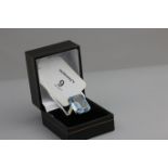 A dress ring, the synthetic step cut blue stone in pierced 9ct gold claw mount