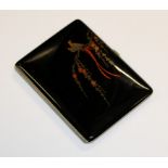 A Japanese black lacquered and overlaid cigarette case, Taisho Period, the hinged front decorated