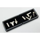 An early 20th century presentation cased set of carved ivory miniature 'working tools', including