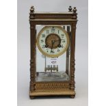 A 19th century French gilt metal four glass mantel clock, the four pillar case with knop finials,