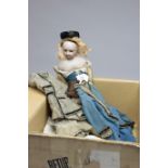 A 19th century porcelain headed doll with swivel head and kid skin body, with hand made contemporary