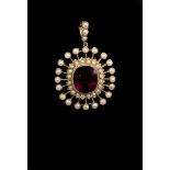 A garnet and pearl cluster pendant, the cushion shaped garnet in millegrain mount, within a double