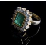 An emerald and diamond cluster ring, the rectangular cut-cornered emerald in a rub-over mount,