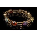 A multi gem set line bracelet, the mixed oval cut stones including citrine, tourmaline, amethyst and