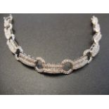 A 14ct white gold cocktail bracelet set with round and baguette cut diamonds - L19cm, approx gross