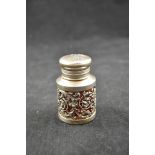 A silver mounted cranberry glass scent bottle, pierced floral design, London 1891, maker Sampson