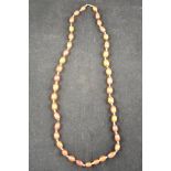 A faceted amber bead necklace comprising forty-one graduated beads interspersed with multi-