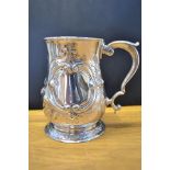 A mid Georgian embossed silver baluster tankard with double scroll handle, uninscribed, London 1756,